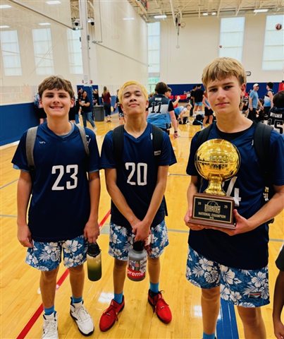 Three boys with the national champion trophy